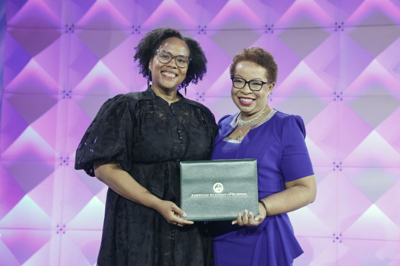 Dr. Nakia Best receiving her American Academy of Nursing fellowship certificate on stage